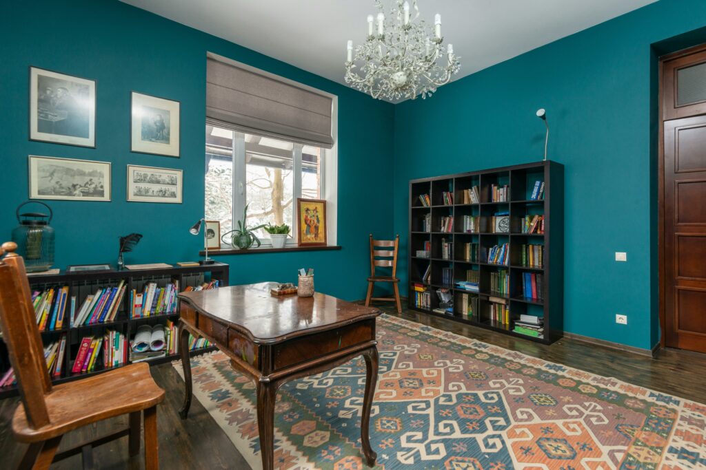 Classic home office design with blue walls and wooden desk